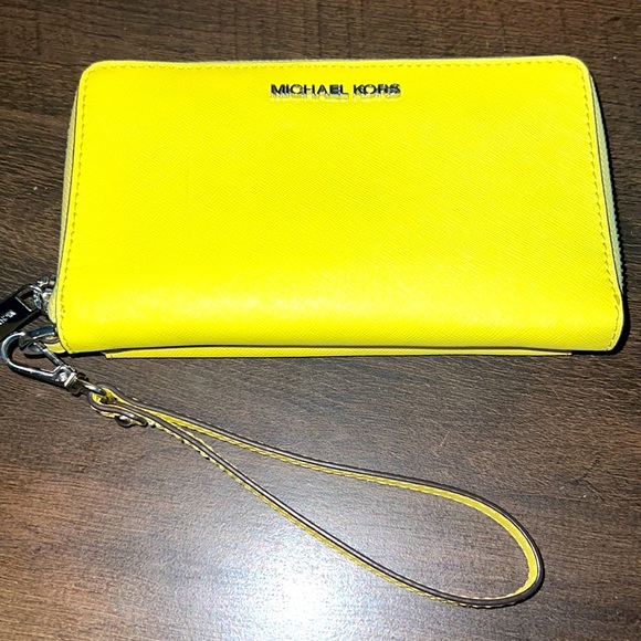 Michael Kors Brand new yellow wristlet w/phone case. Gild hardware.